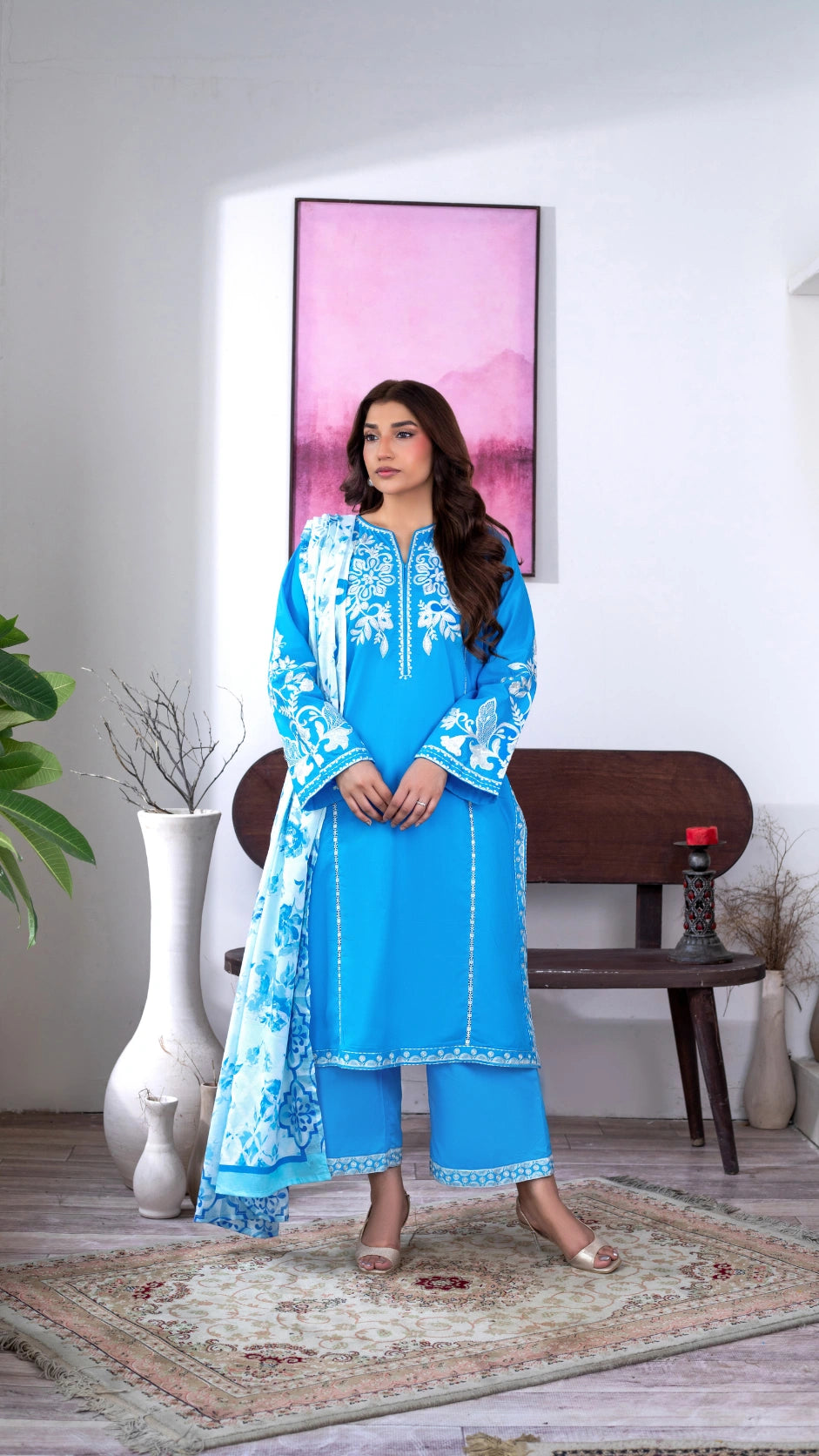 Modest Pakistani women’s fashion featuring a vibrant blue embroidered kurta