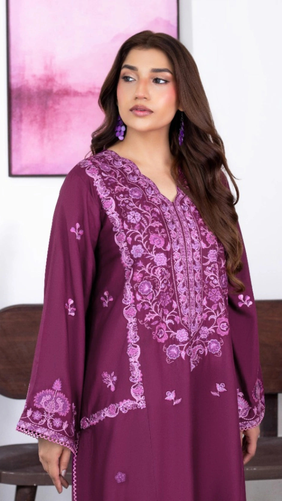 Plum ethnic dress featuring delicate floral motifs and decorative borders