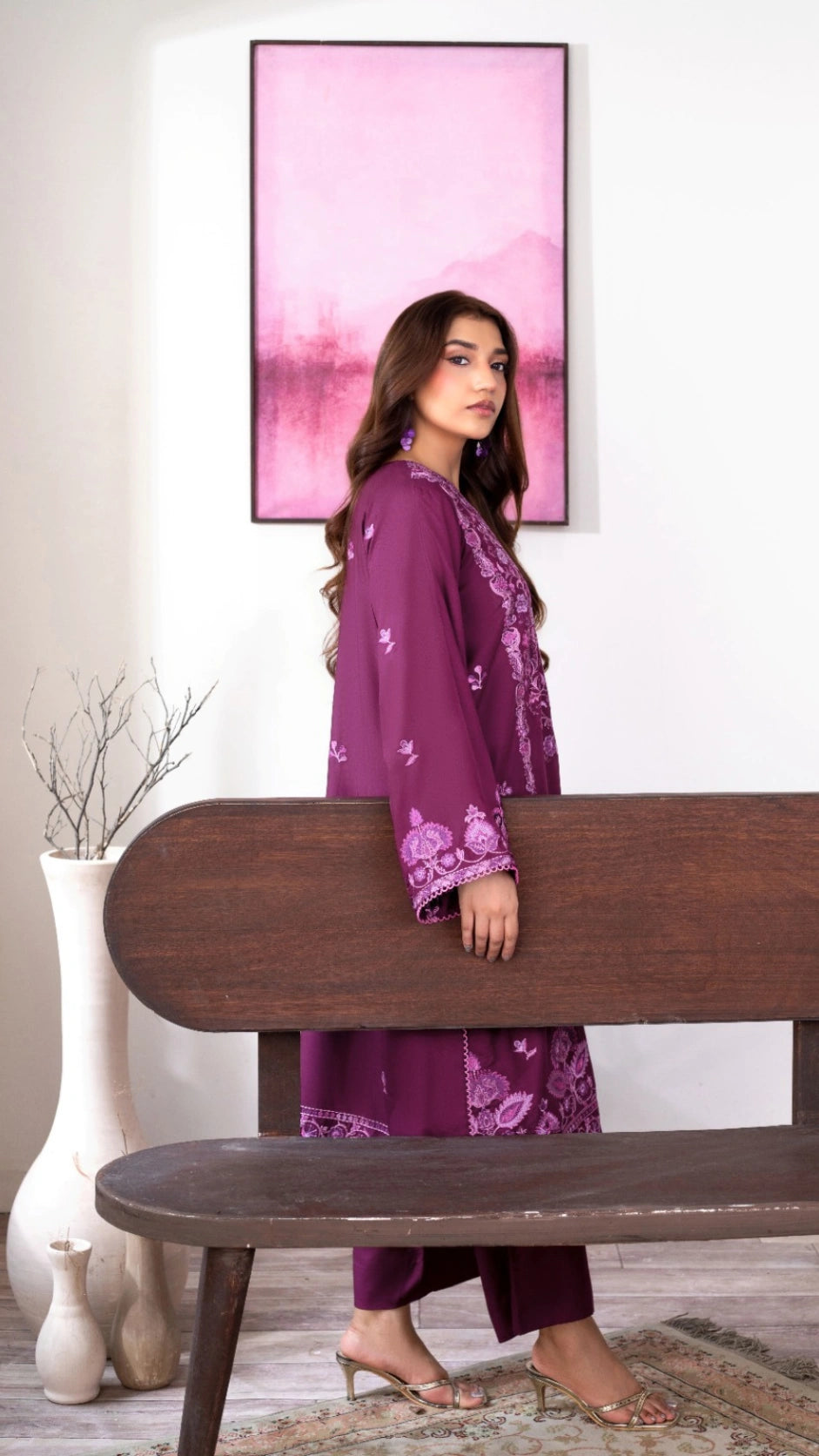 Plum traditional dress worn by a woman in an elegant indoor setting